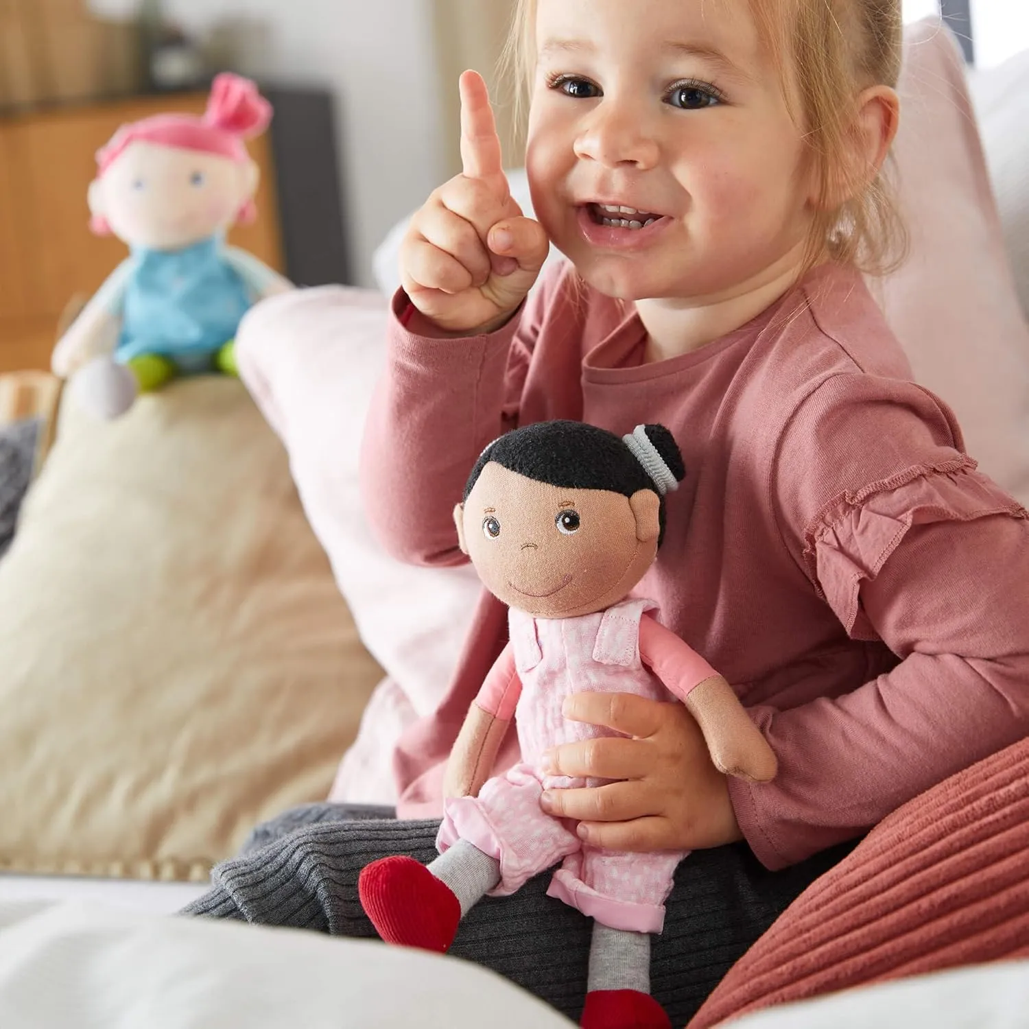HABA Snug Up Doll Rumbi - 10" Soft Doll with Black Hair and Pink Overalls - Machine Washable for 18 Months and Up