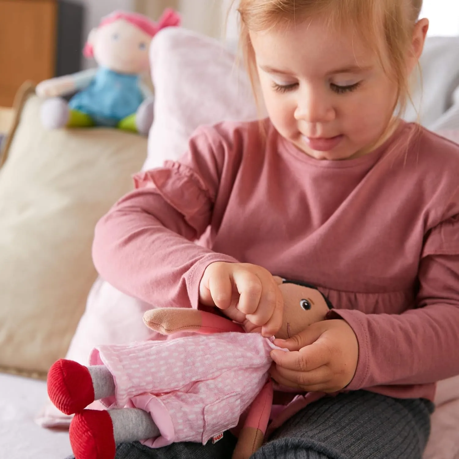 HABA Snug Up Doll Rumbi - 10" Soft Doll with Black Hair and Pink Overalls - Machine Washable for 18 Months and Up