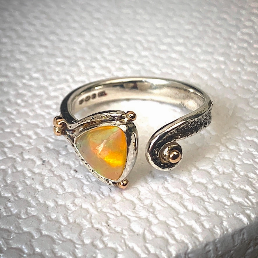 Solid sterling silver and gold ring set with incredible, ethically sourced,Ethiopian opal. Size R