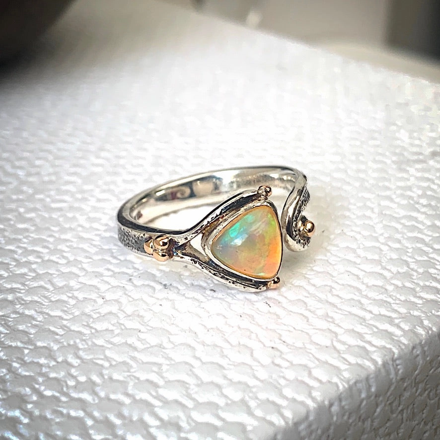 Solid sterling silver and gold ring set with incredible, ethically sourced,Ethiopian opal. Size R