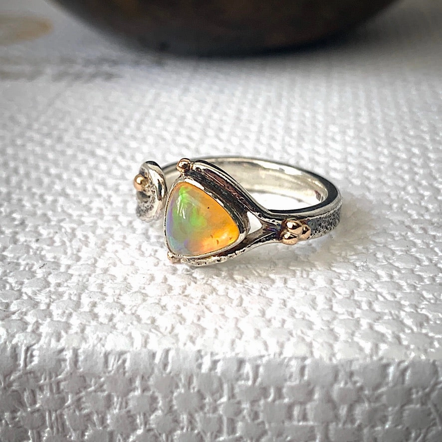 Solid sterling silver and gold ring set with incredible, ethically sourced,Ethiopian opal. Size R