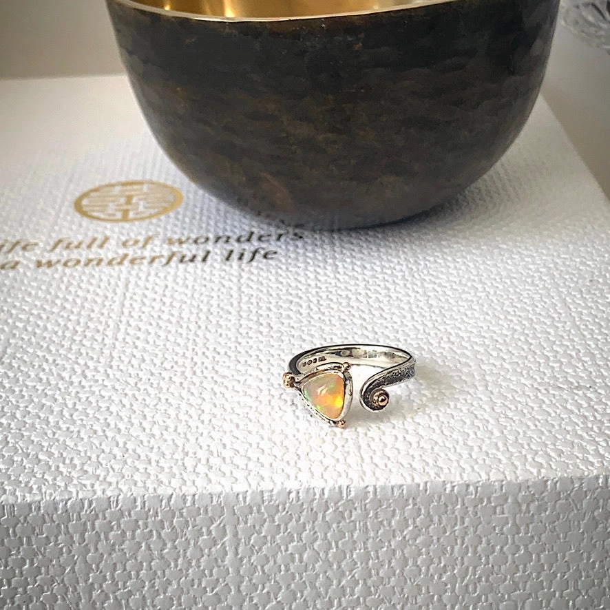 Solid sterling silver and gold ring set with incredible, ethically sourced,Ethiopian opal. Size R