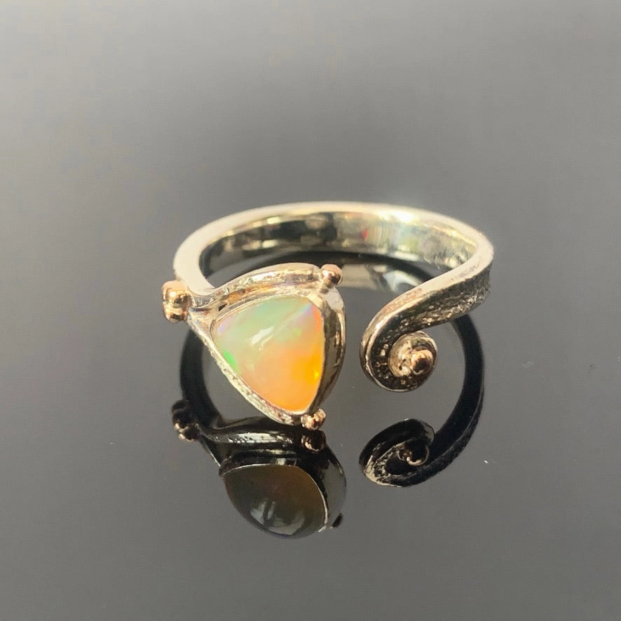 Solid sterling silver and gold ring set with incredible, ethically sourced,Ethiopian opal. Size R