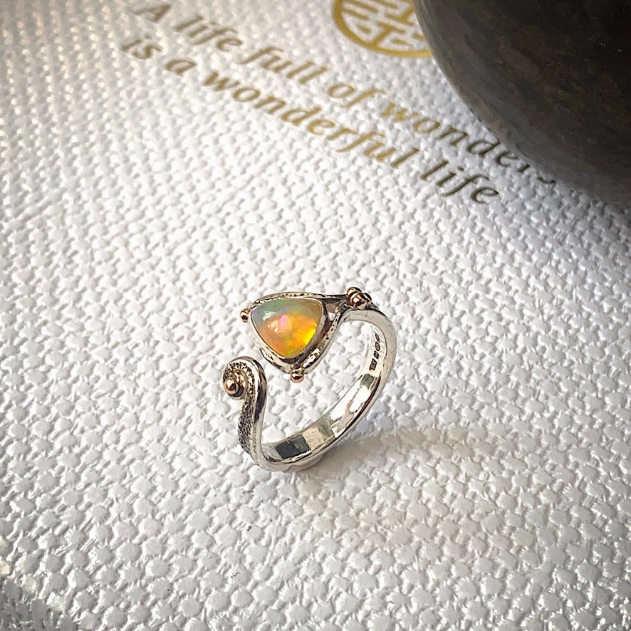 Solid sterling silver and gold ring set with incredible, ethically sourced,Ethiopian opal. Size R