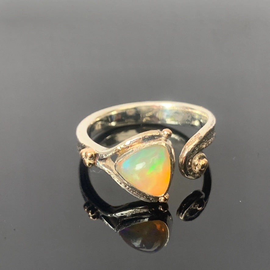 Solid sterling silver and gold ring set with incredible, ethically sourced,Ethiopian opal. Size R